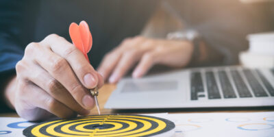 Businessman holding red dart push on target. Business strategy planning success target goals. Business development concept